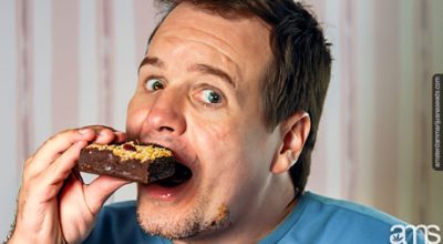 a man with big eyes eats an edible